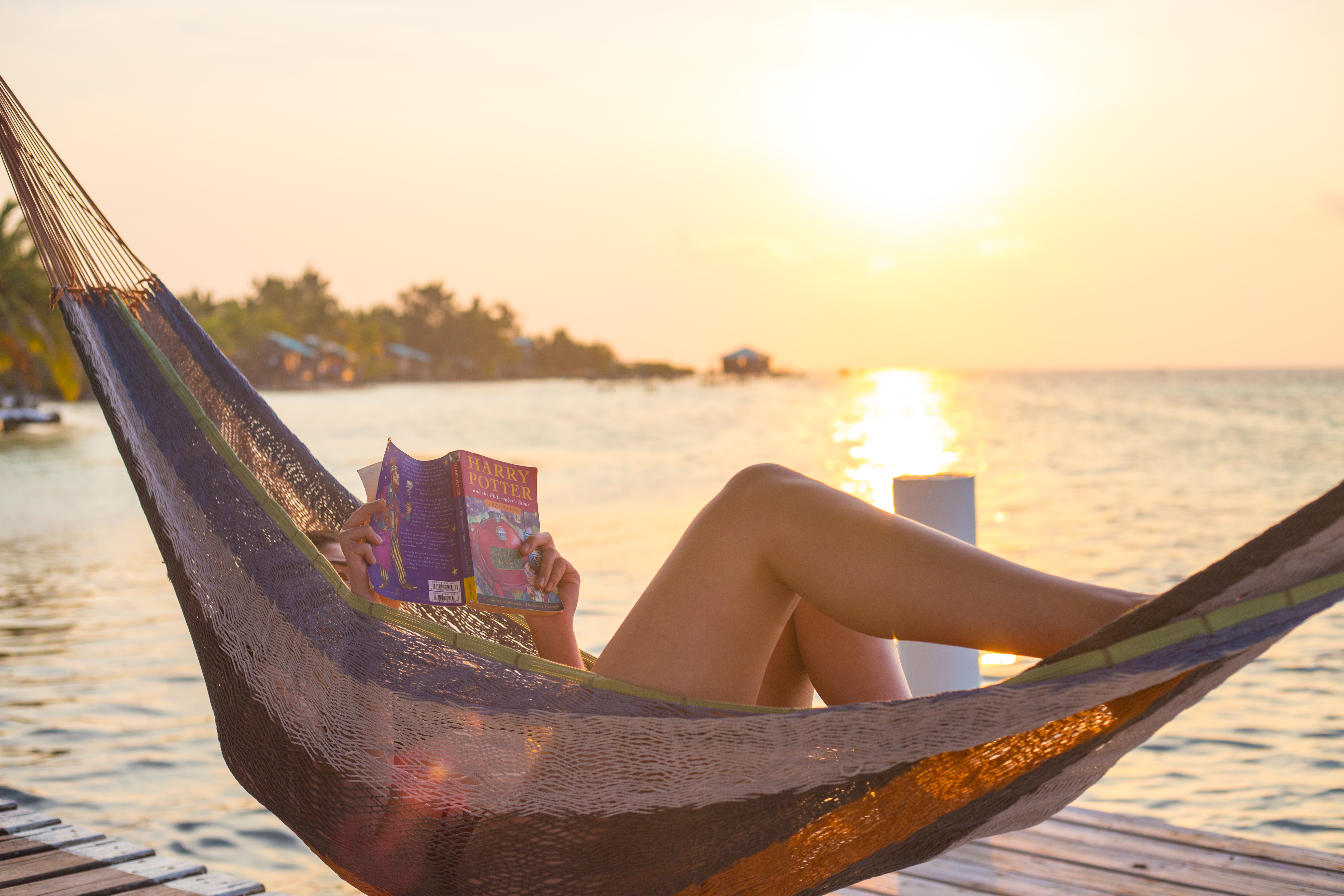 Reading a book in Belize in a hammock