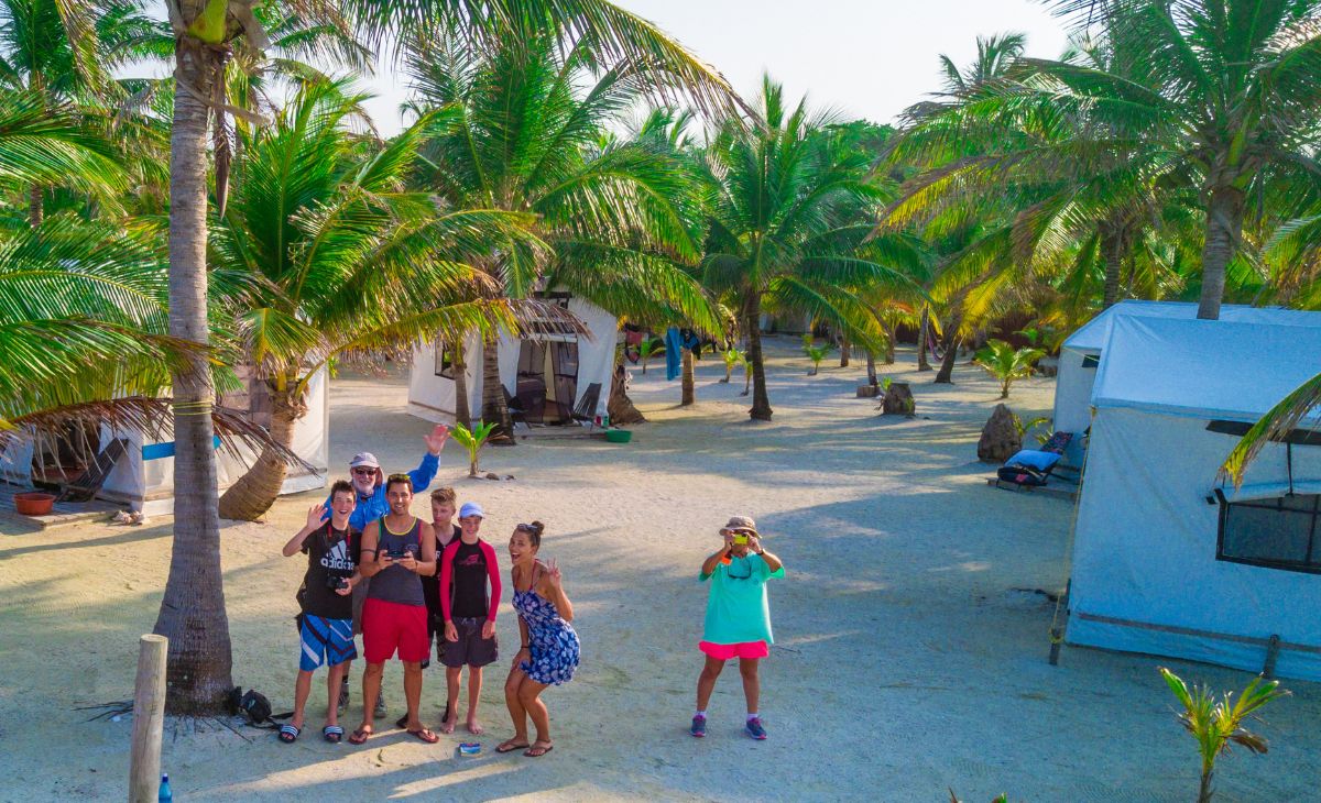 Family at Glover's Reef Basecamp playing with drone