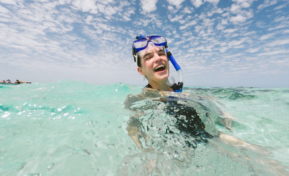 Woman enjoying snorkeling in Belize clear waters