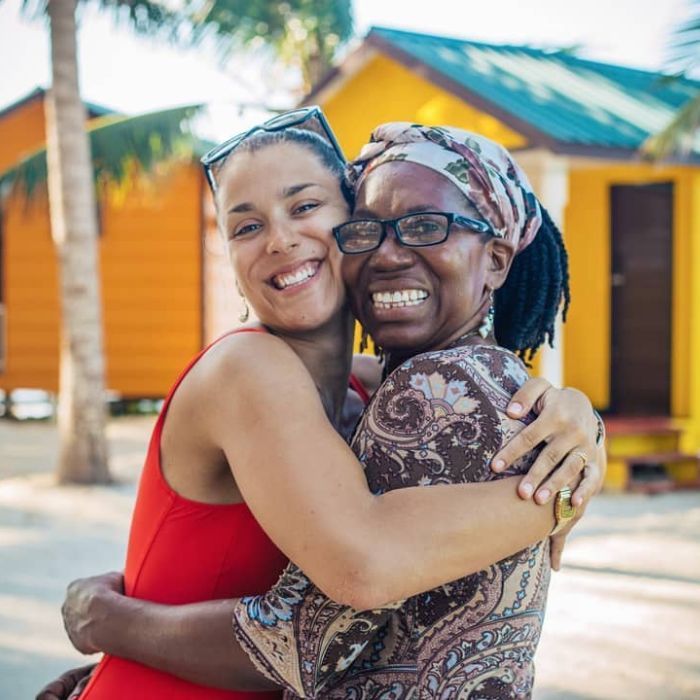 Traveler embracing resident Garifuna