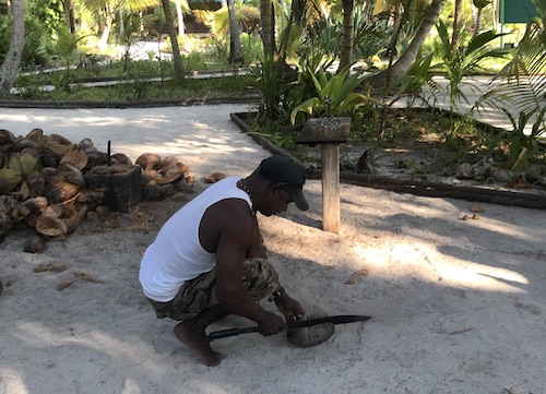 Guide Omar cracking open a coconut