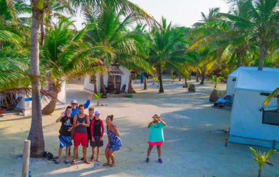 Family at Glover's Reef Basecamp playing with drone