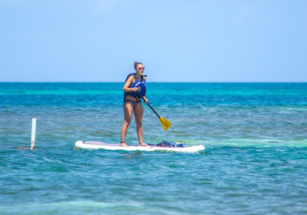girl paddle boarding in Belize