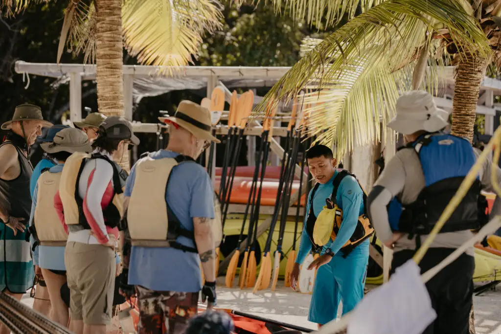 Guiding doing a kayaking introduction for guests at Glover's Reef in Belize