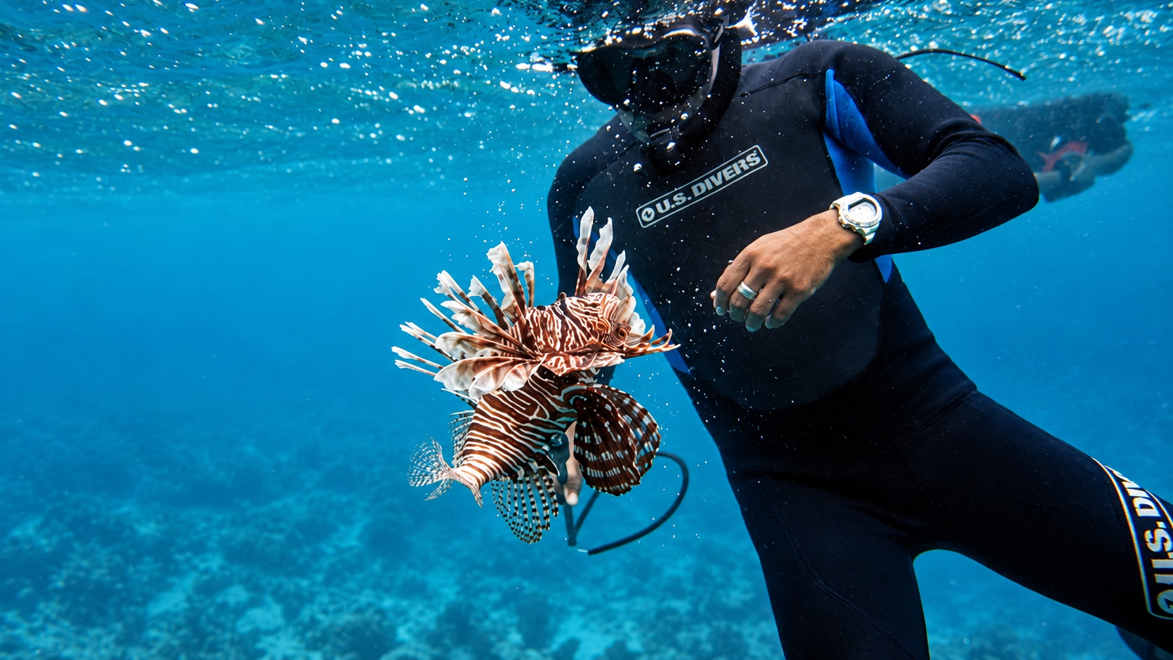 Belize guide posing with a Lionfish that he speared