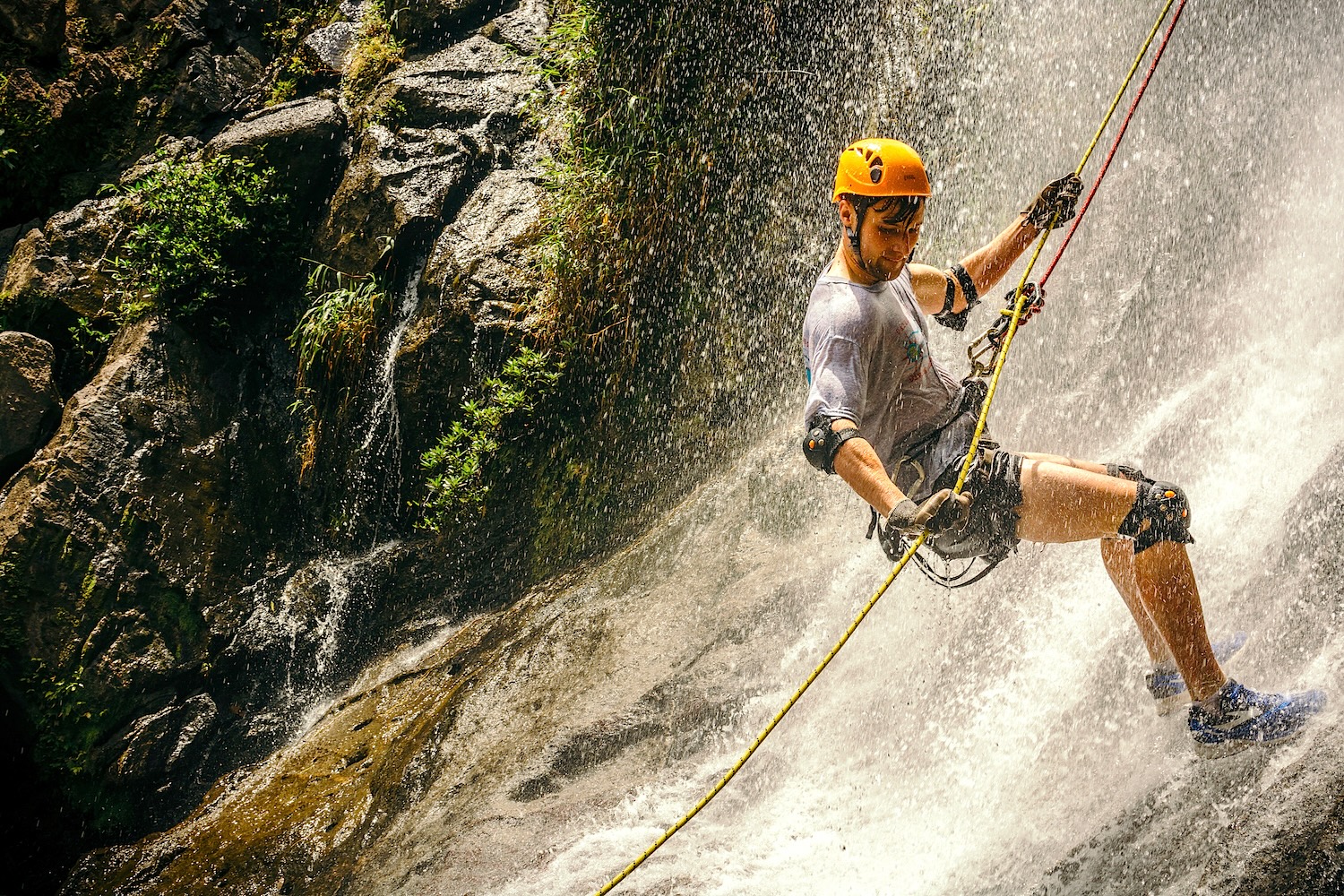 person Rappeling down a waterfall in Belize