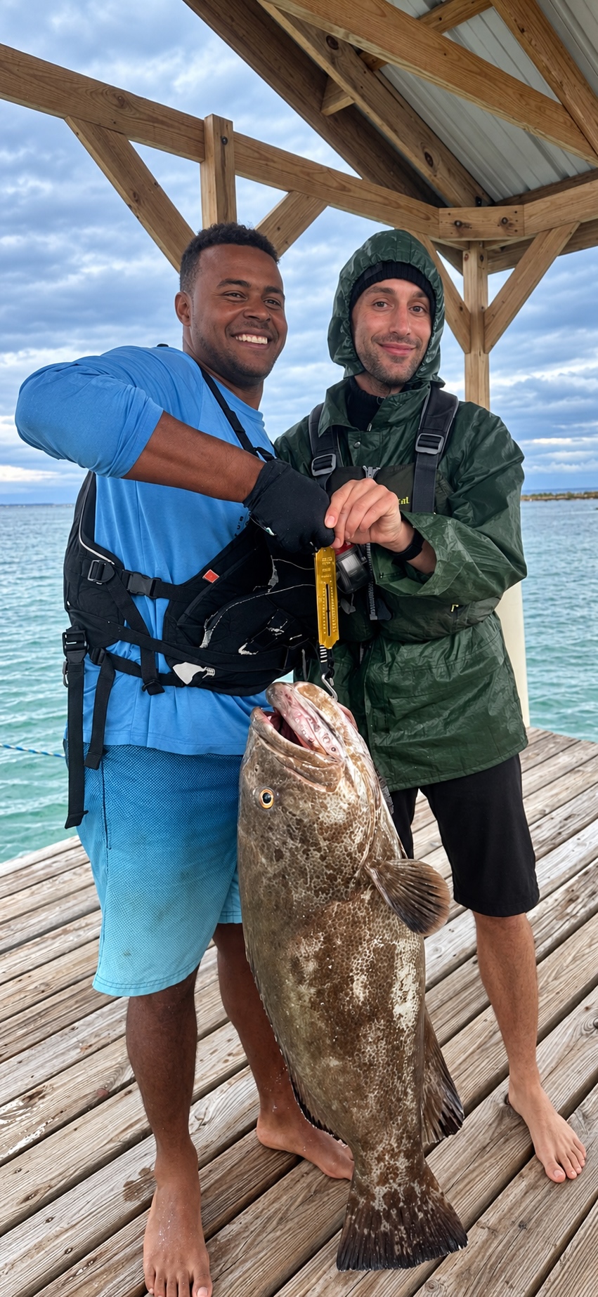 fishing guide holds a giant black grouper for a picture