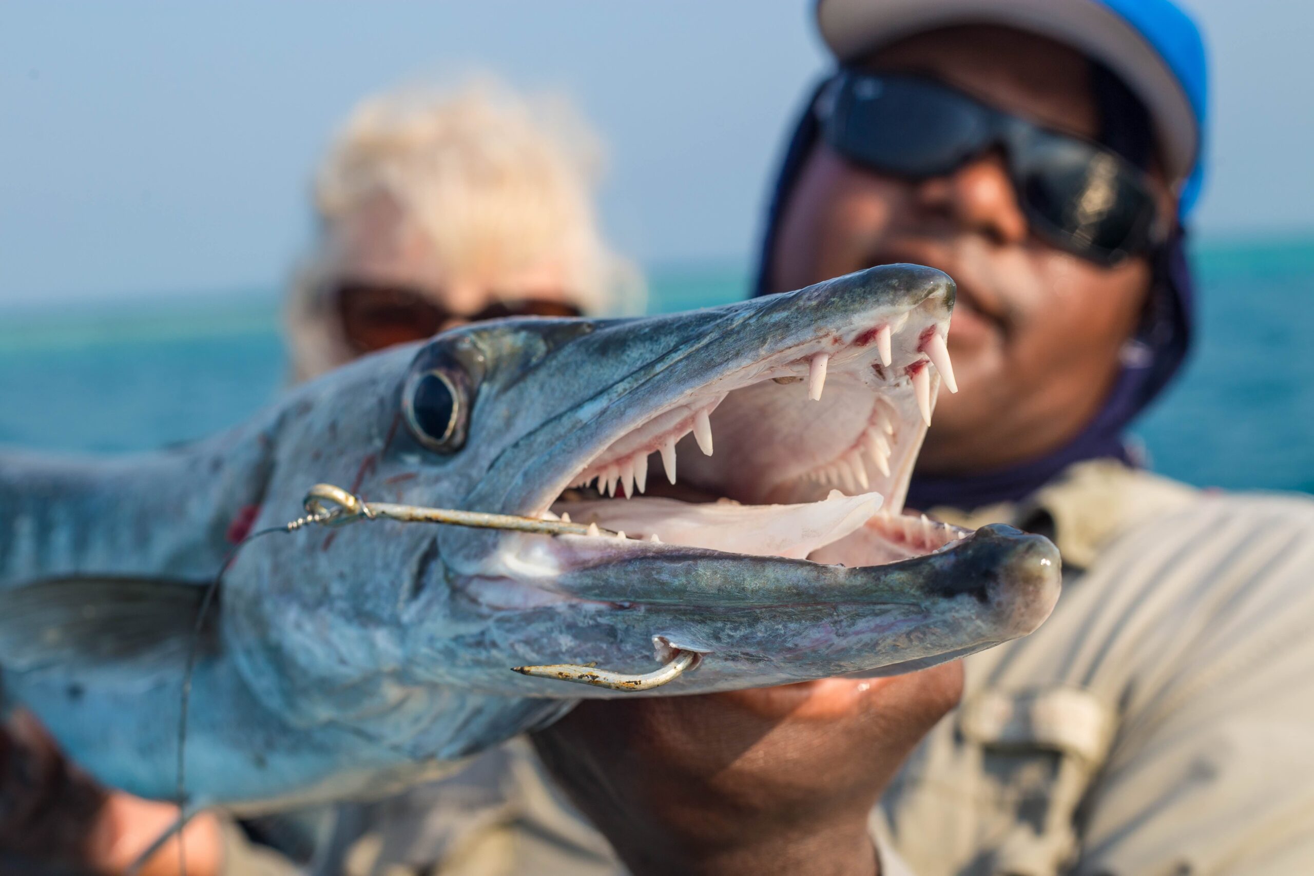 fishing guide poses with a barracuda in Belize