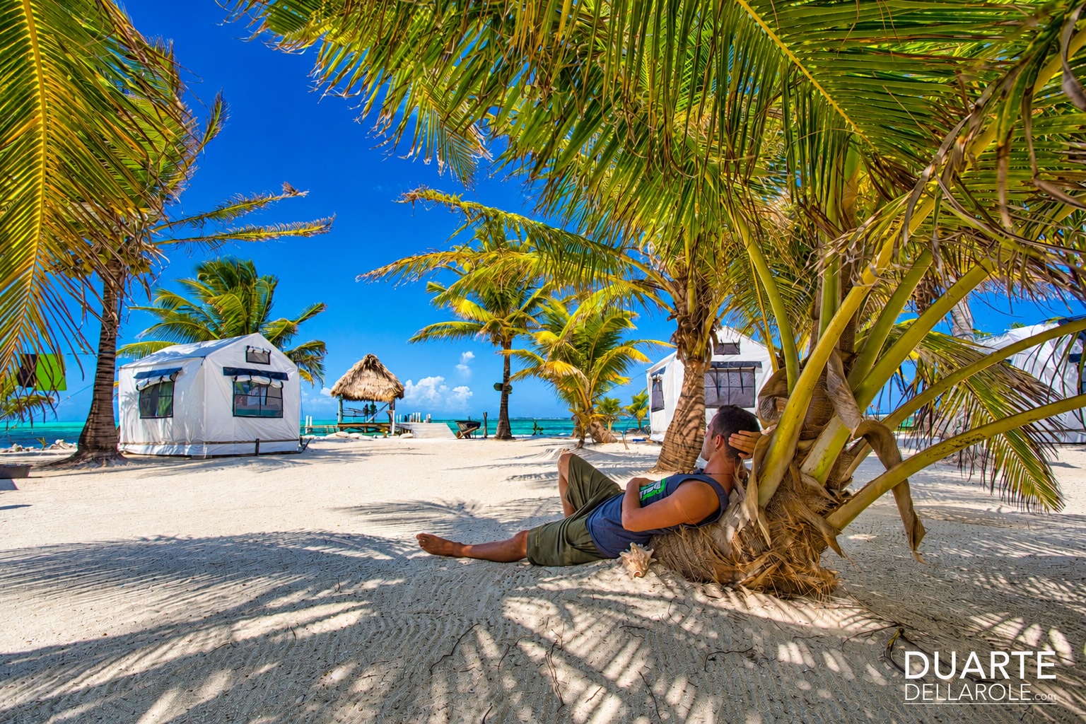 Person relaxing on a beach at Glover's Reef in Belize