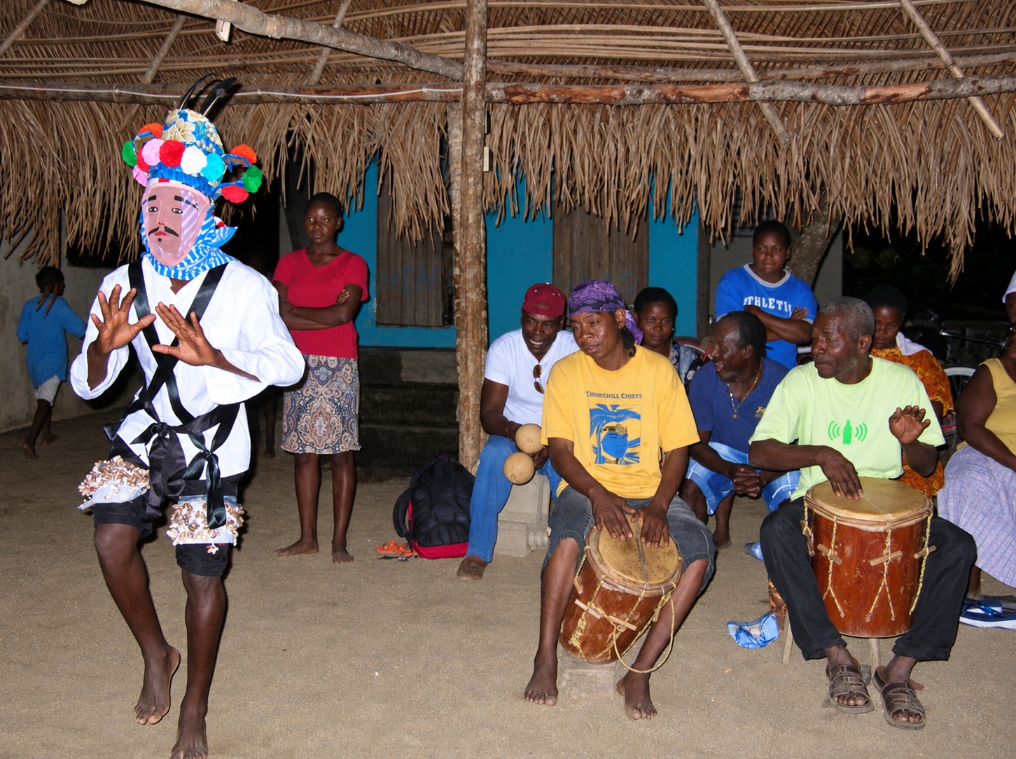 Garifuna drummers and traditional dancer enjoying a performance