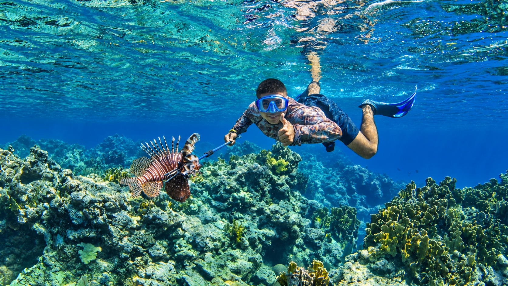 Guide in Belize with a Lionfish on a spear