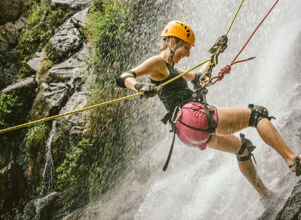 Woman rappelling down a waterfall in Belize