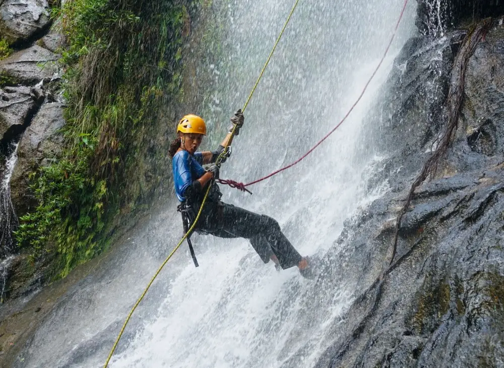 Person rapelling a waterfall at Bocawina in Belize