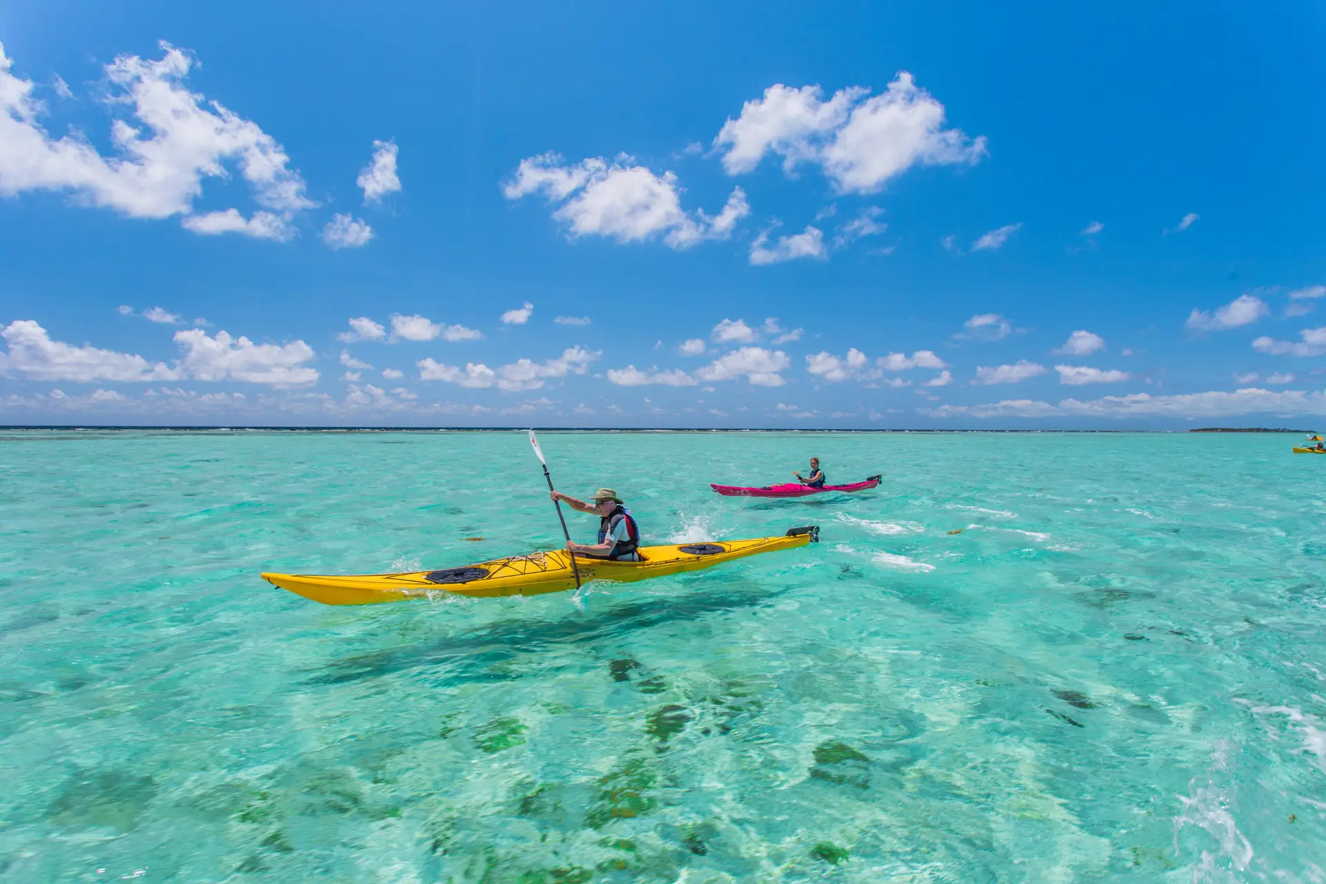 Kayakers gliding through crystal clear waters in Belize