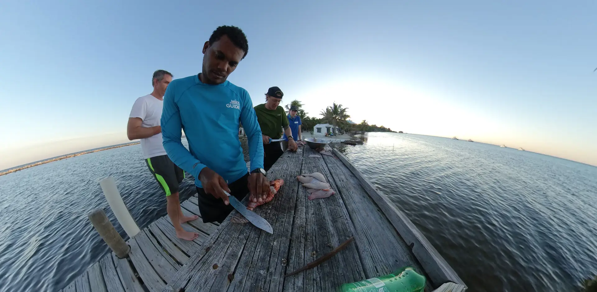 Belizean fisherman cleaning Lionfish at Glover's Reef in Belize