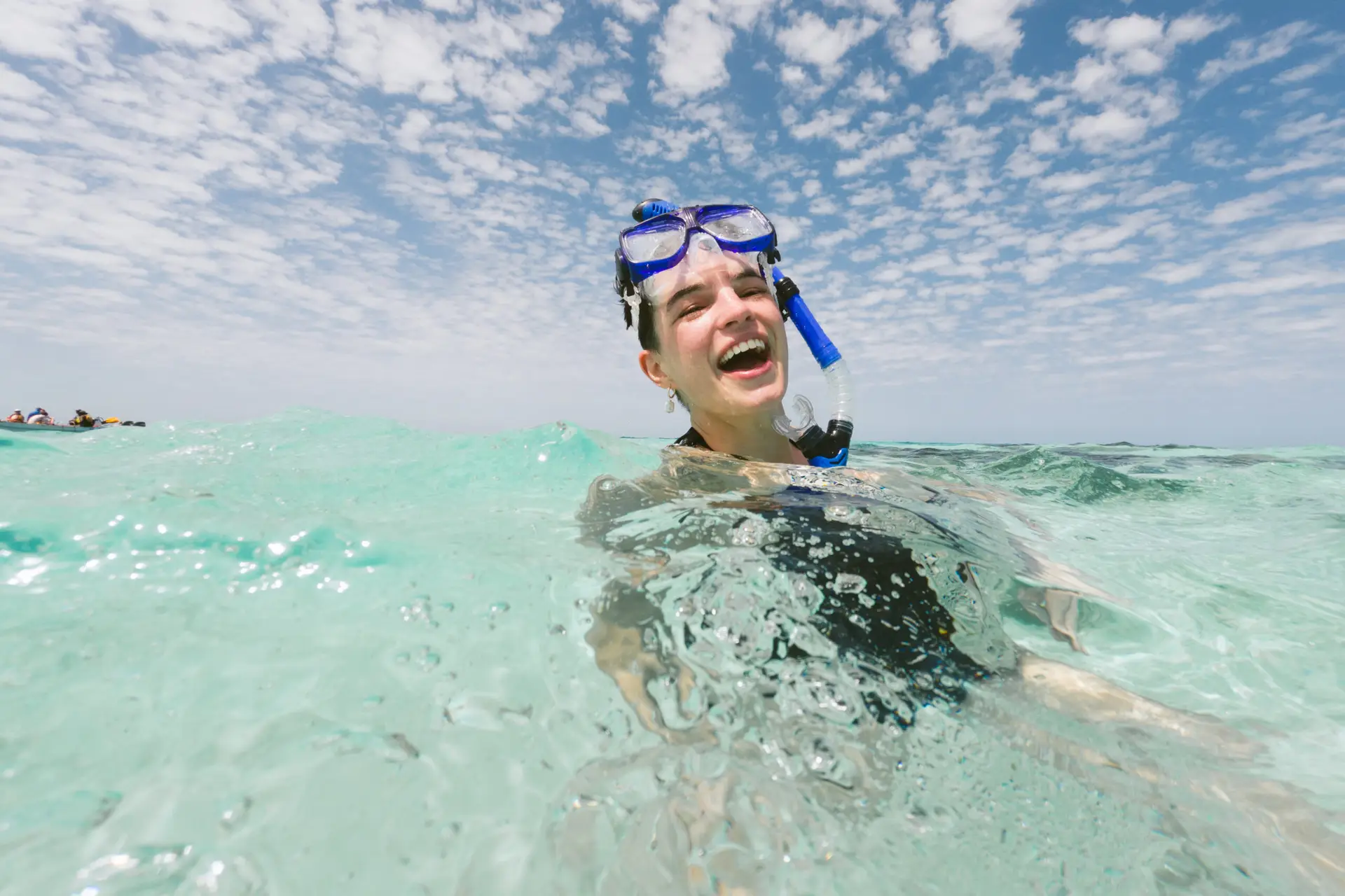 Guest snorkeling in crystal clear waters in Belize